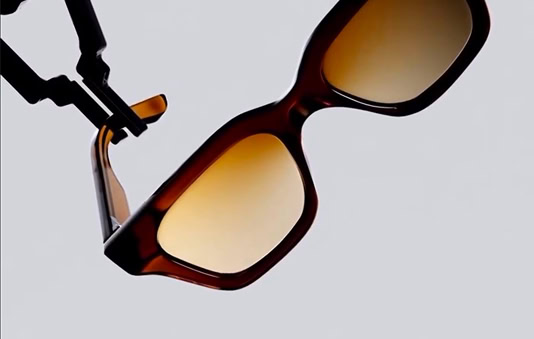 A pair of sunglasses hanging from a hook.